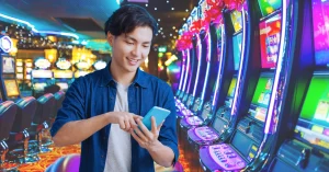 Young Man Use Phone - Slot Machines in Casino Background
