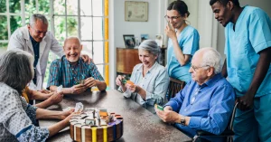 Senior Friends Playing Cards in Nursing Home