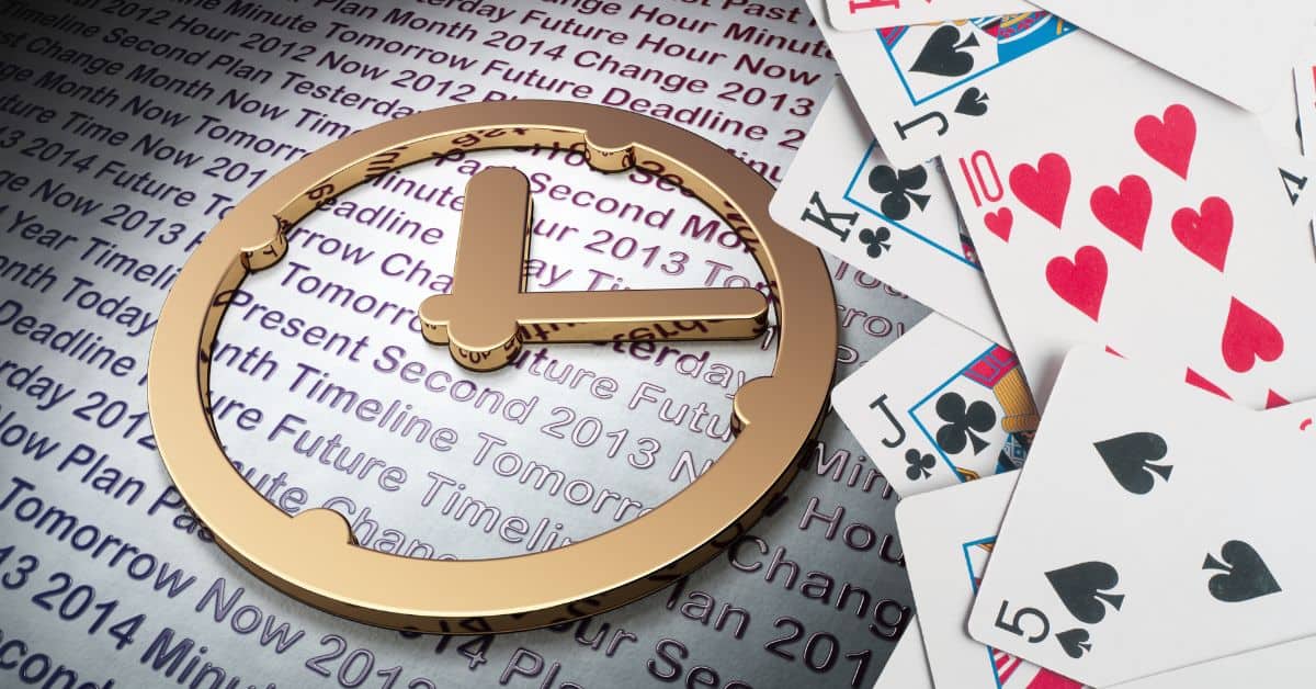 cards on top of book and gold clock emblem