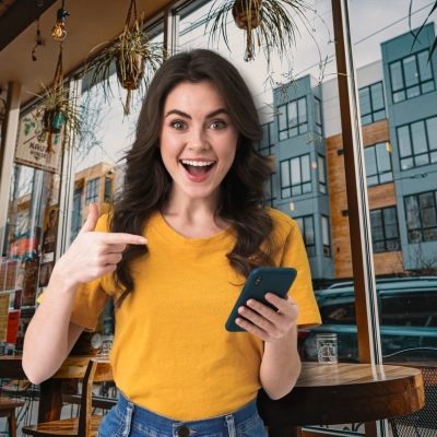 Surprised Young Girl Using Mobile Phone Pointing