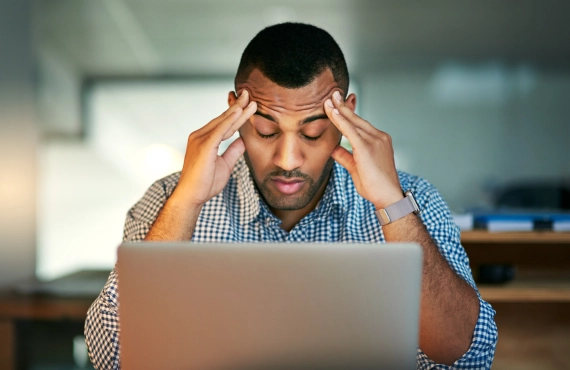 Man Looking Stressed Out Sitting in Front of Laptop 