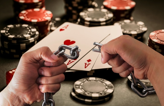 Poker Cards and Chips on Black Background, Gambling Casino Table - Hands Breaking a Chain